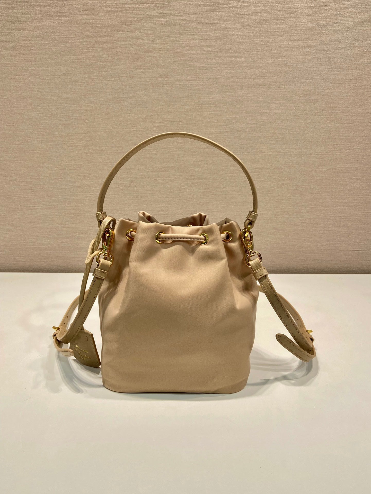 PRADA BUCKET BAG 19 IN BEIGE RE-NYLON AND SAFFIANO LEATHER HANDLE