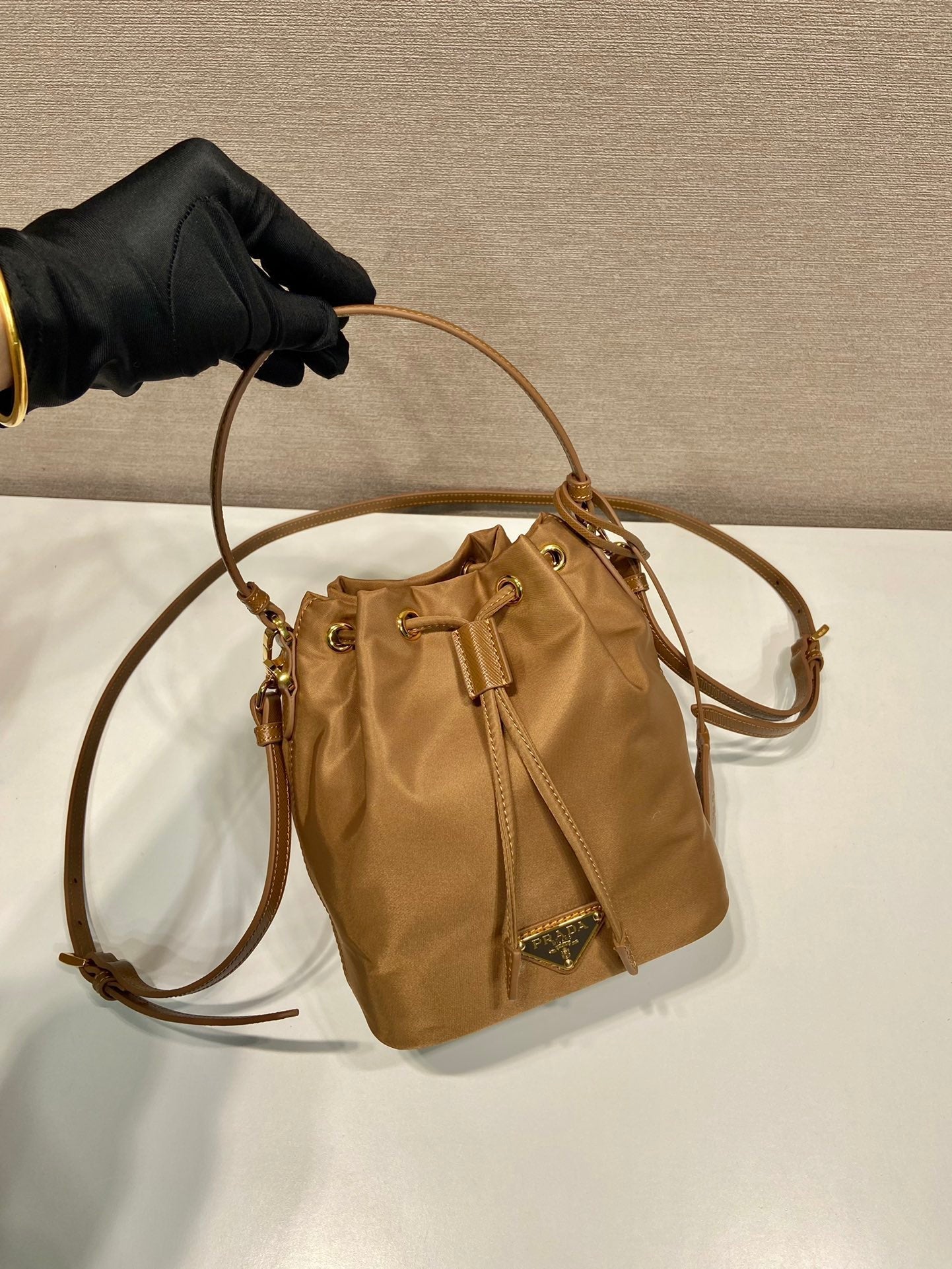 PRADA BUCKET BAG 19 IN RUSSET BROWN RE-NYLON AND CALFSKIN HANDLE