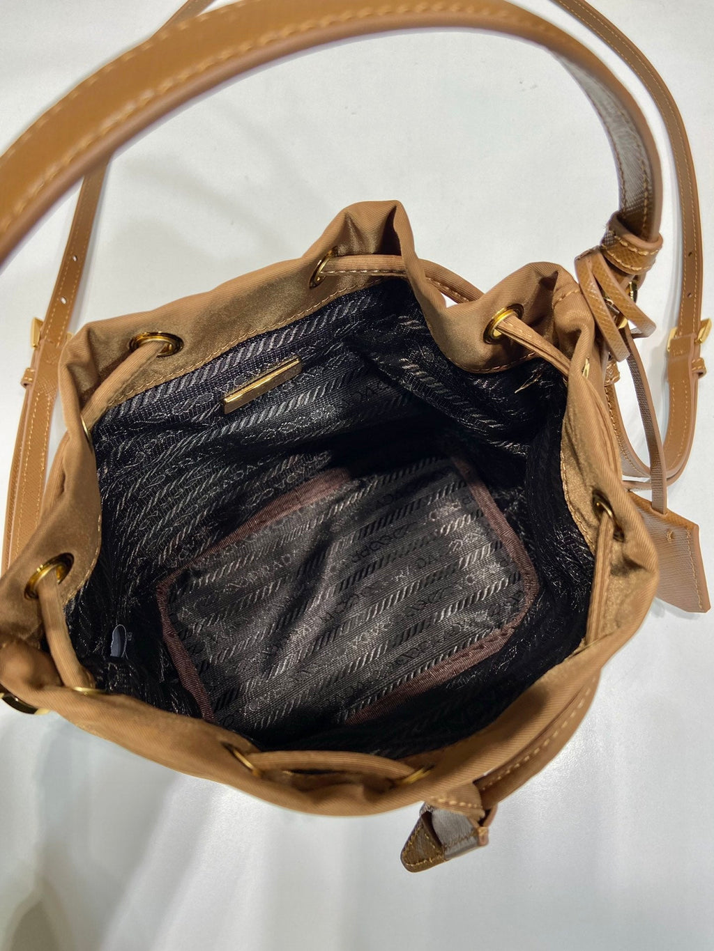 PRADA BUCKET BAG 19 IN RUSSET BROWN RE-NYLON AND CALFSKIN HANDLE