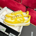 CHANEL TRAINERS IN BRIGHT YELLOW SHINY CALFSKIN