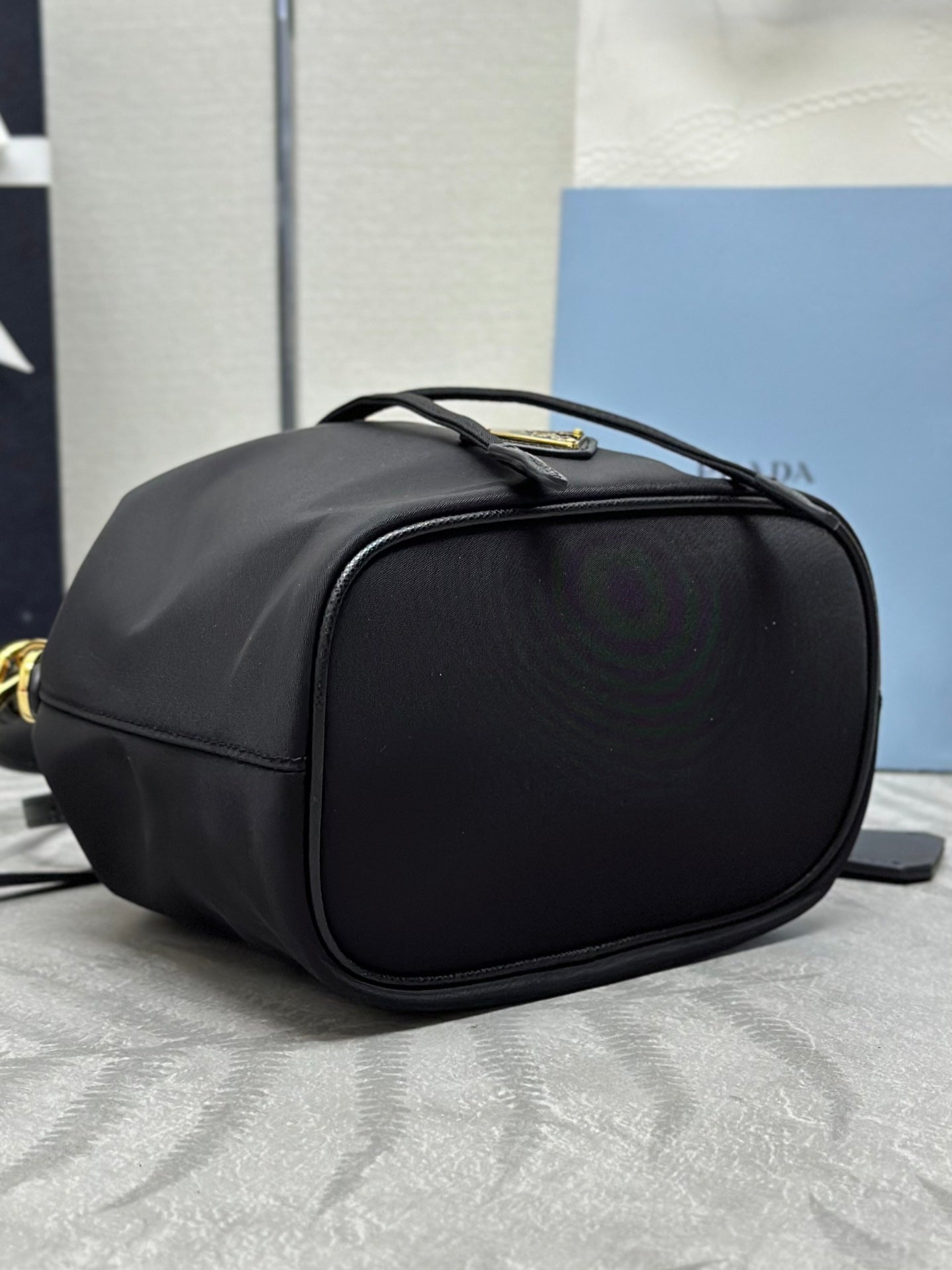 PRADA BUCKET BAG 19 IN BLACK RE-NYLON AND CALFSKIN HANDLE
